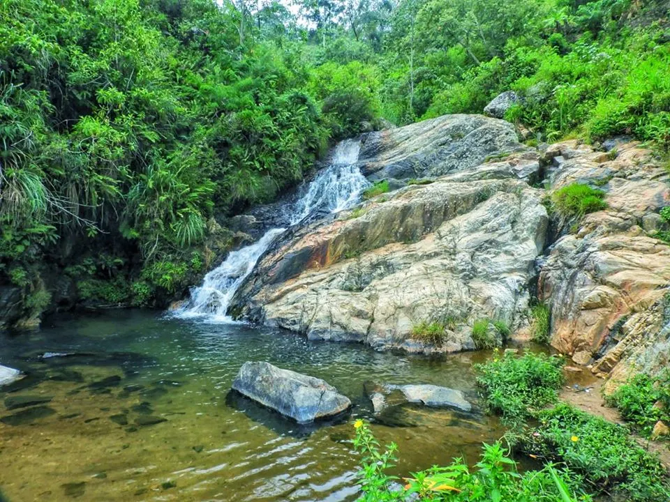 Besama Water Fall flowing into a shallow natural pool